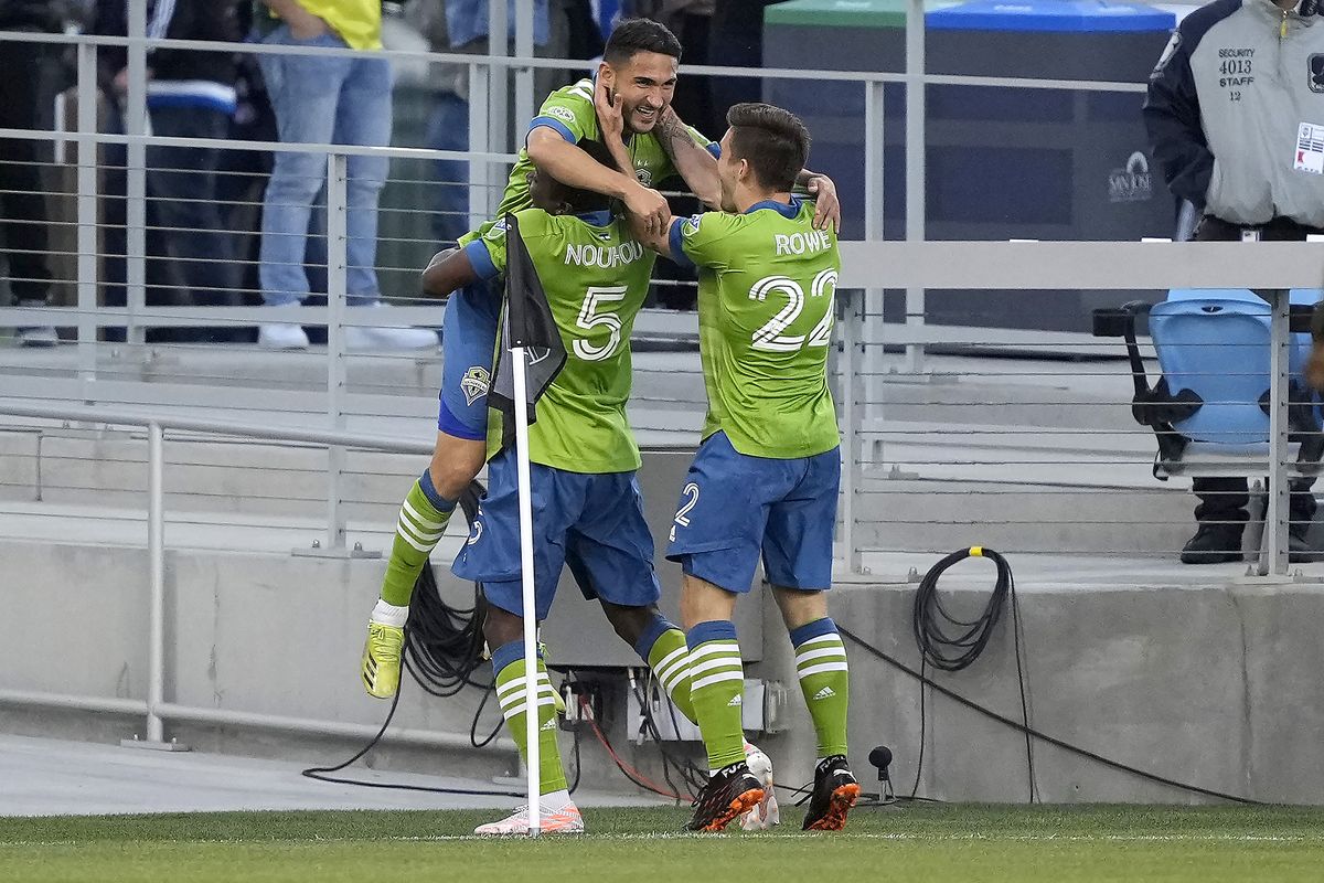 Seattle Sounders midfielder Cristian Roldan, top, celebrates with Nouhou Tolo (5) and Kelyn Rowe (22) after scoring a goal against the San Jose Earthquakes during the first half of an MLS soccer match Wednesday, May 12, 2021, in San Jose, Calif.  (Associated Press)