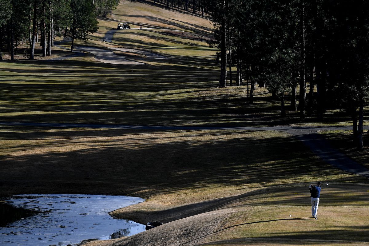 A golfer tees off on Thursday, March 4, 2021, at the Creek at Qualchan Golf Course in Spokane, Wash. Golfers took to the course to enjoy the sun and opening day.  (Tyler Tjomsland/THE SPOKESMAN-RE)