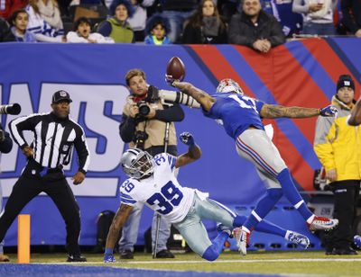 The Giants’ Odell Beckham Jr. makes a one-handed catch for a touchdown against the Cowboys’ Brandon Carr. (Associated Press)