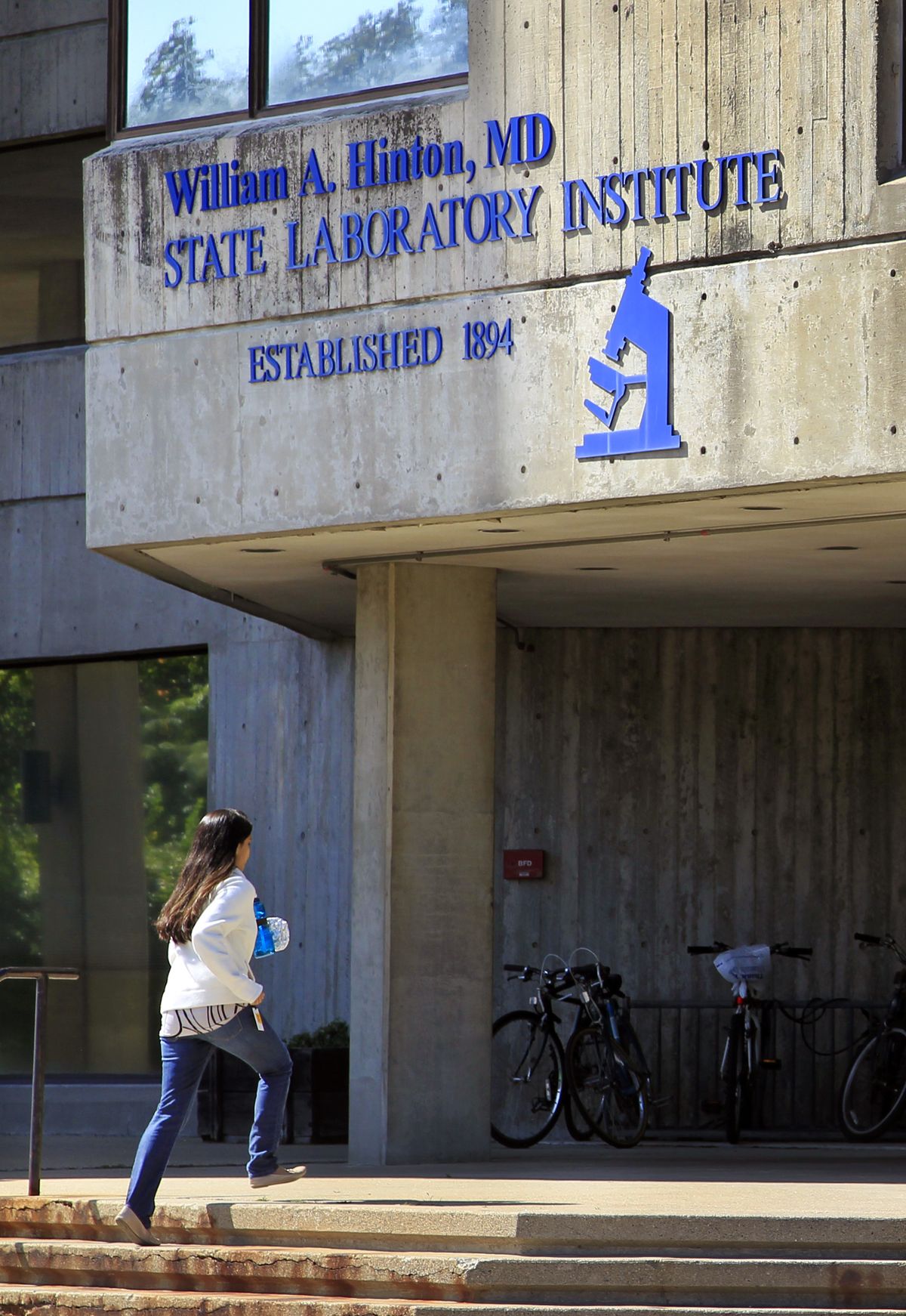 A woman enters the William A. Hinton State Laboratory Institute, which houses the Massachusetts state drug lab, in the Jamaica Plain neighborhood of Boston, Thursday, Sept. 27, 2012. Documents revealed Wednesday that a crime lab chemist, whose work has thrown thousands of prosecutions into question, spend years faking results. (Steven Senne / Associated Press)
