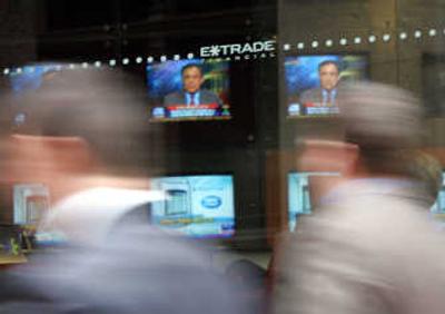 
People walk by the Boston office of online discount broker E-Trade Financial Corp. in May  2005. Associated Press
 (Associated Press / The Spokesman-Review)