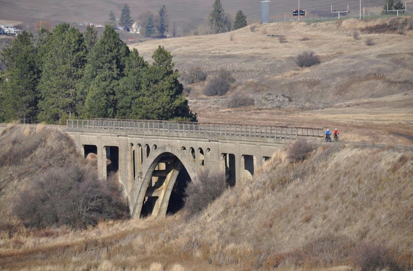 Cyclists cross a century-old trestle near Rosalia on the John Wayne Trail, which runs 253 miles across Washington. (Rich Landers / The Spokesman-Review)
