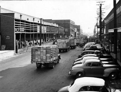 
 It's bumper  to bumper as  trucks deliver freshly picked fruit to the packing houses and cold storage rooms during apple harvest in 1956. 
 (File / The Spokesman-Review)