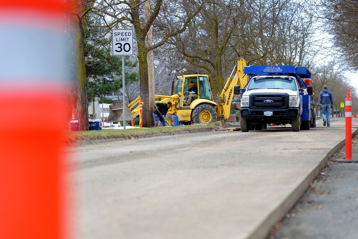 Road crews work on Mission Avenue near Gonzaga University in Spokane in 2018. After state residents voted to  limit vehicle registration fees,  a majority of Spokane City Council members said they are open to asking local voters to reinstate an annual $20 car registration fee, or find other tax sources, to fund local road maintenance projects. (Kathy Plonka / The Spokesman-Review)