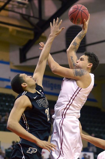 Washington State center Jordan Railey, right, puts up a shot in front of Purdue center A.J. Hammons for two of his 13 points in the Cougars win over the Boilermakers in the Old Spice Classic tournament in Kissimmee, Fla., on Friday. (Associated Press)