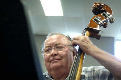 Bill Gotfredson plays the bass during a Tuxedo Junction rehearsal last week.
(The Spokesman-Review)