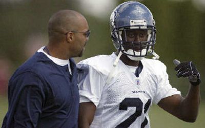 
Kelly Jennings gets pointers from defensive backs coach Teryl Austin, left, in his attempt to earn a starting spot. 
 (Associated Press / The Spokesman-Review)