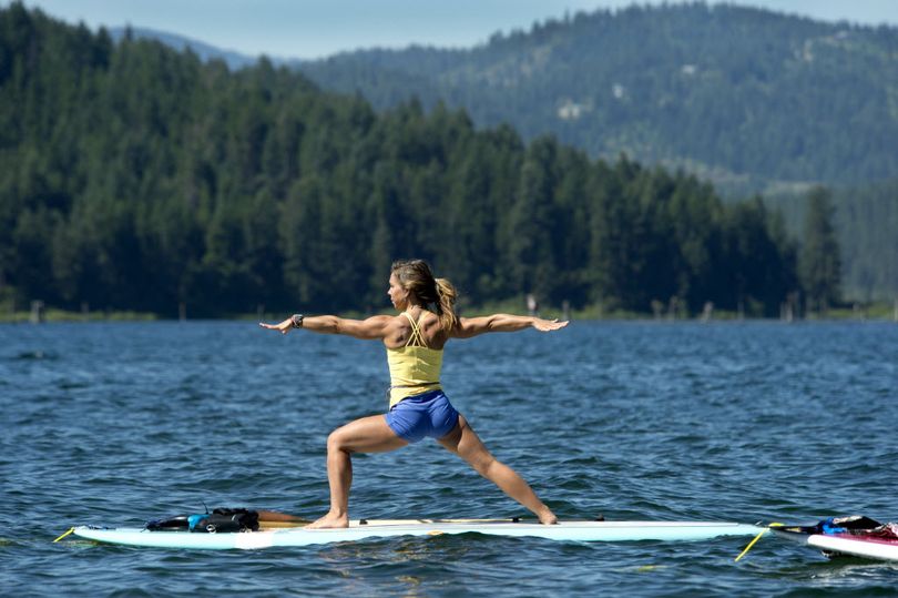 Paddle board instructor Katie Fitzgerald strike the 