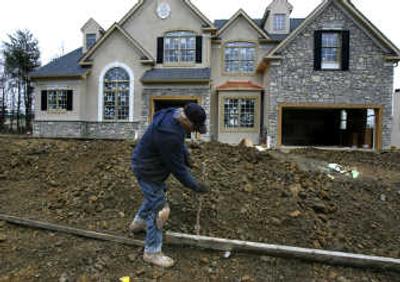 
Kye Long works on laying a form for a sidewalk in front of a home under construction in Spring House, Pa. The prolonged slump in housing pushed construction of new homes in 2007 down by the largest amount in 27 years with the expectation that the downturn has further to go. 
 (Associcated Press / The Spokesman-Review)