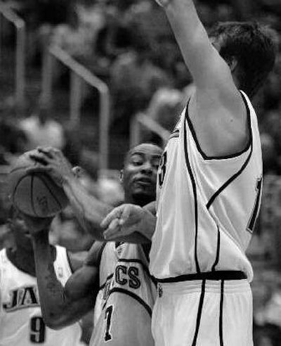 
Utah's Mehmet Okur, right, defends Seattle's Rashard Lewis. 
 (Associated Press / The Spokesman-Review)