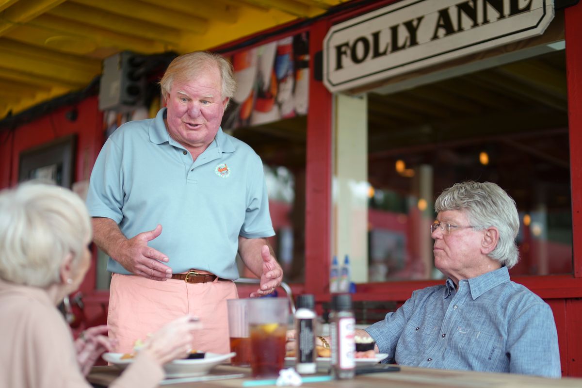 John Keener, a restauranteur, speaks with diners at the Charleston Crab House in Charleston, S.C., on Thursday. He said he has been understaffed since the early days of the pandemic and is looking to employ more staff as the season revs up.  (SEAN RAYFORD)