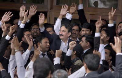 Chief Justice Iftikhar Mohammed Chaudhry, center, is greeted at his home in Islamabad on Monday.  (Associated Press / The Spokesman-Review)