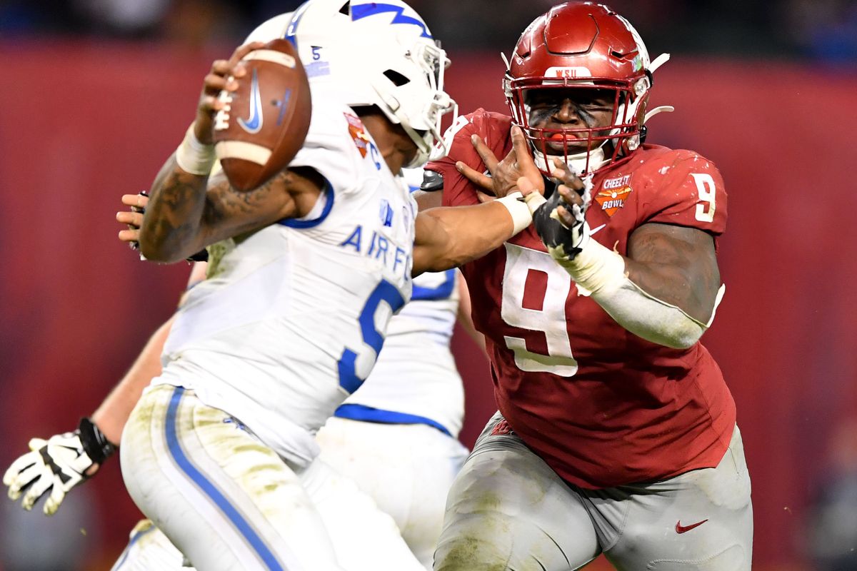 Washington State Cougars defensive lineman Lamonte McDougle (9) puts pressure on Air Force Falcons quarterback Donald Hammond III (5) during the second half of the Cheez-It Bowl on Friday, December 27, 2019, at Chase Field in Phoenix, Ariz. Air Force won the game 31-21.  (TYLER TJOMSLAND)