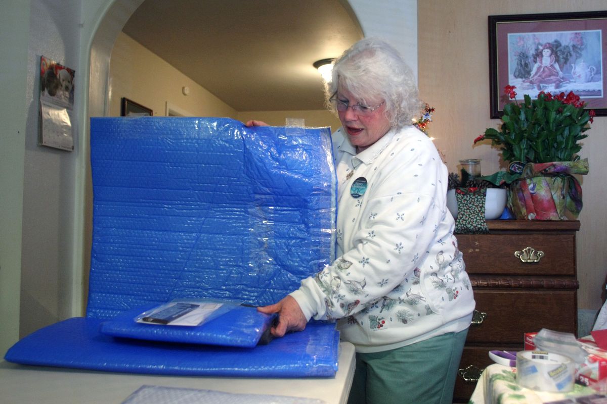 Sheri Rose puts the pillow inside one of her completed homeless mats. (Larry Steagall photos)
