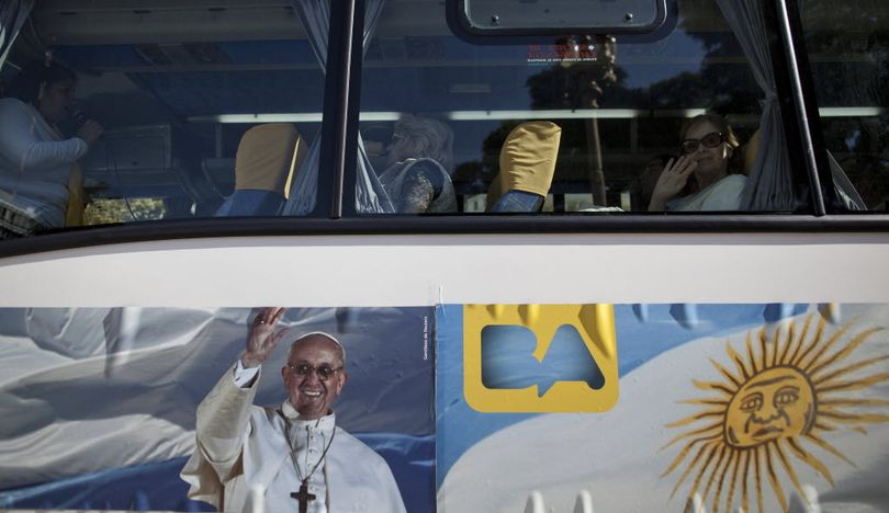The Pope Francis Bus. In this May 11, 2013 photo, passengers sit in the single-story cruiser tour bus decorated with a banner of Pope Francis and the Argentine flag in Buenos Aires, Argentina. With an Argentine on the throne of St. Peter, the South American country's capital city has launched a series of guided tours. Three-hour weekend bus trips and walking tours are so far non-commercial in the first step at papal tourism. .  (AP Photo/Natacha Pisarenko)