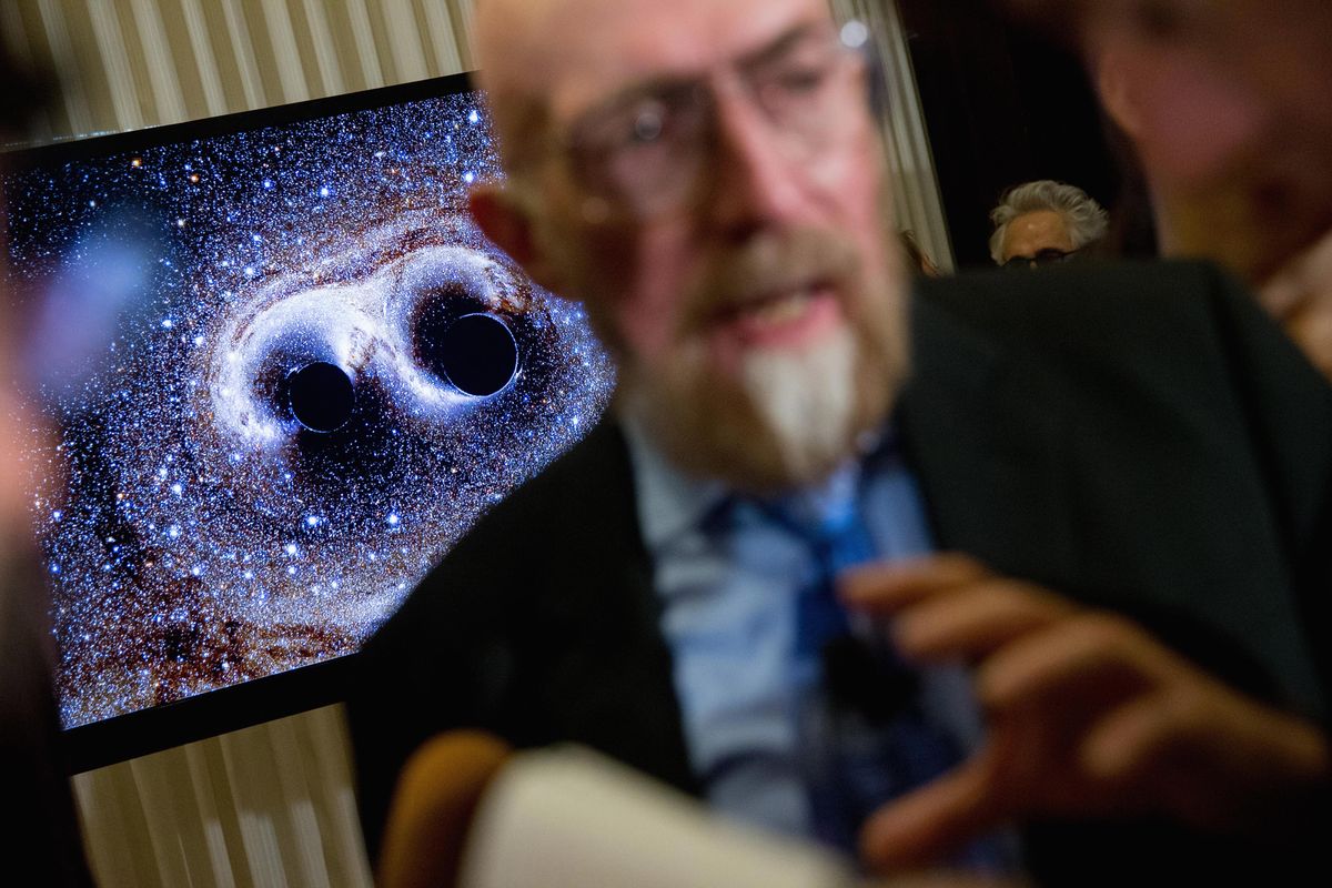 A visual of gravitational waves from two converging black holes is depicted on a monitor behind Laser Interferometer Gravitational-Wave Observatory co-founder Kip Thorne as he speaks to members of the media following a news conference at the National Press Club in Washington, D.C., Thursday, Feb. 11, 2016, as it is announced that scientists they have finally detected gravitational waves, the ripples in the fabric of space-time that Einstein predicted a century ago. The announcement has electrified the world of astronomy, and some have likened the breakthrough to the moment Galileo took up a telescope to look at the planets. (Andrew Harnik / Associated Press)
