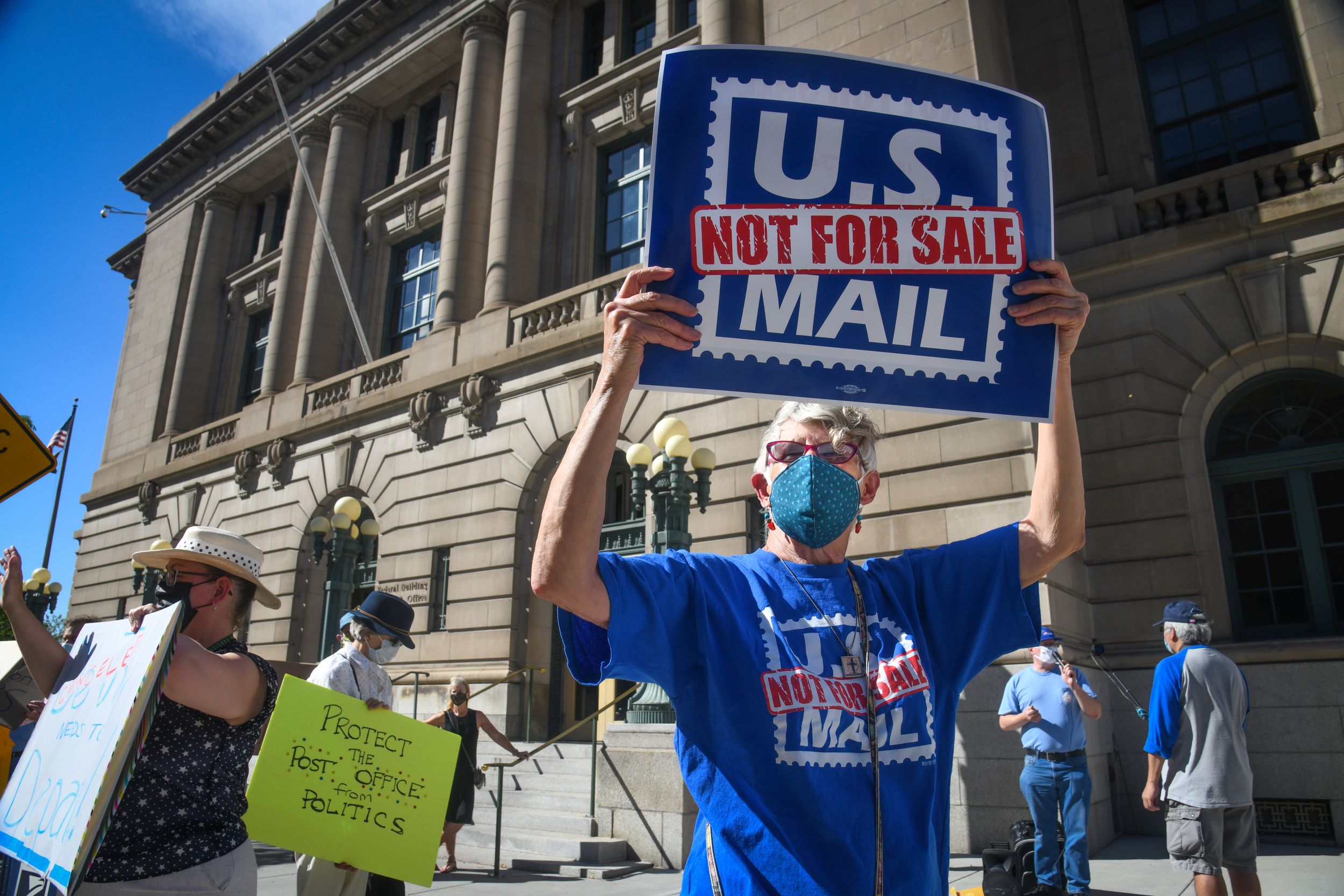 USPS 'not to be messed with' Postal workers, protesters gather at
