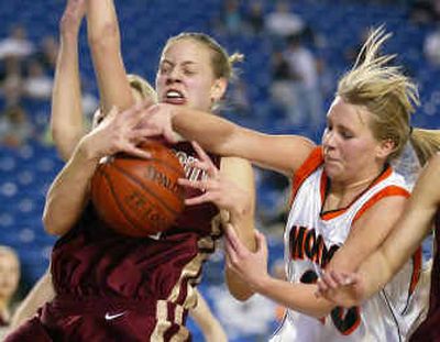 
University's Angie Bjorklund, left, who scored 20 points, battles with Monroe's Chelsea Drivstuen for a rebound during the first quarter of their State 4A tournament game. 
 (John Froschauer/Special to / The Spokesman-Review)