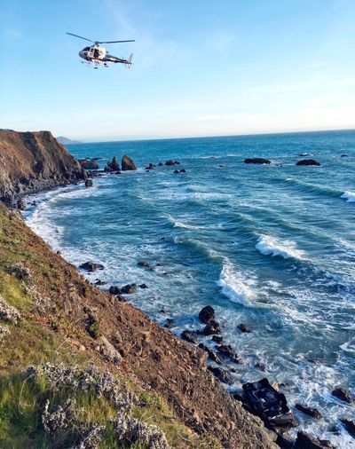 In this March 27, 2018, file photo provided by the California Highway Patrol a helicopter hovers over steep coastal cliffs near Mendocino, Calif., where a vehicle, visible at lower right, plunged about 100 feet off a cliff along Highway 1, killing all passengers. The SUV was carrying the Hart family, from Woodland, Wash. (AP / California Highway Patrol)