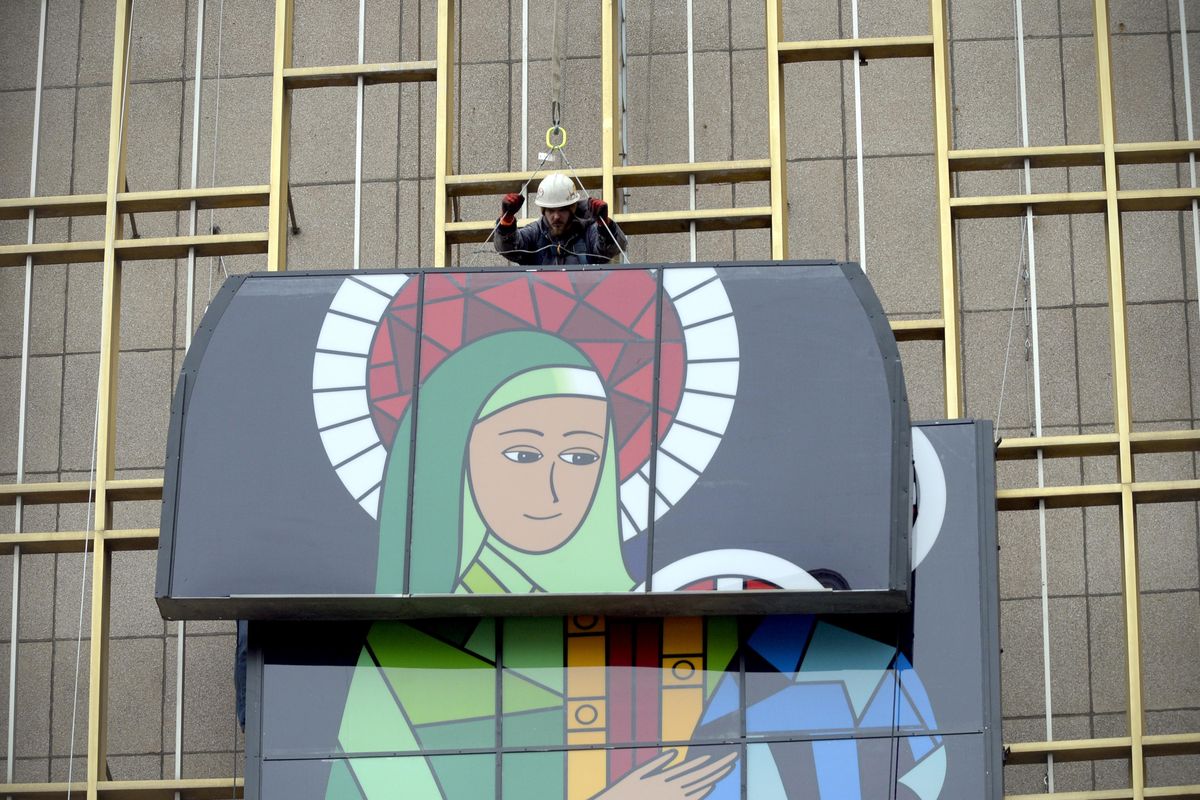 Tad Delong of Baldwin Sign guides one of the last pieces into place as he helps to install the lighted Madonna and Christ Child Christmas display in 2014. The lighted display will be installed on the east face of the Cathedral Plaza apartments, 1120 W. Sprague Ave., this holiday season. (Jesse Tinsley / The Spokesman-Review)