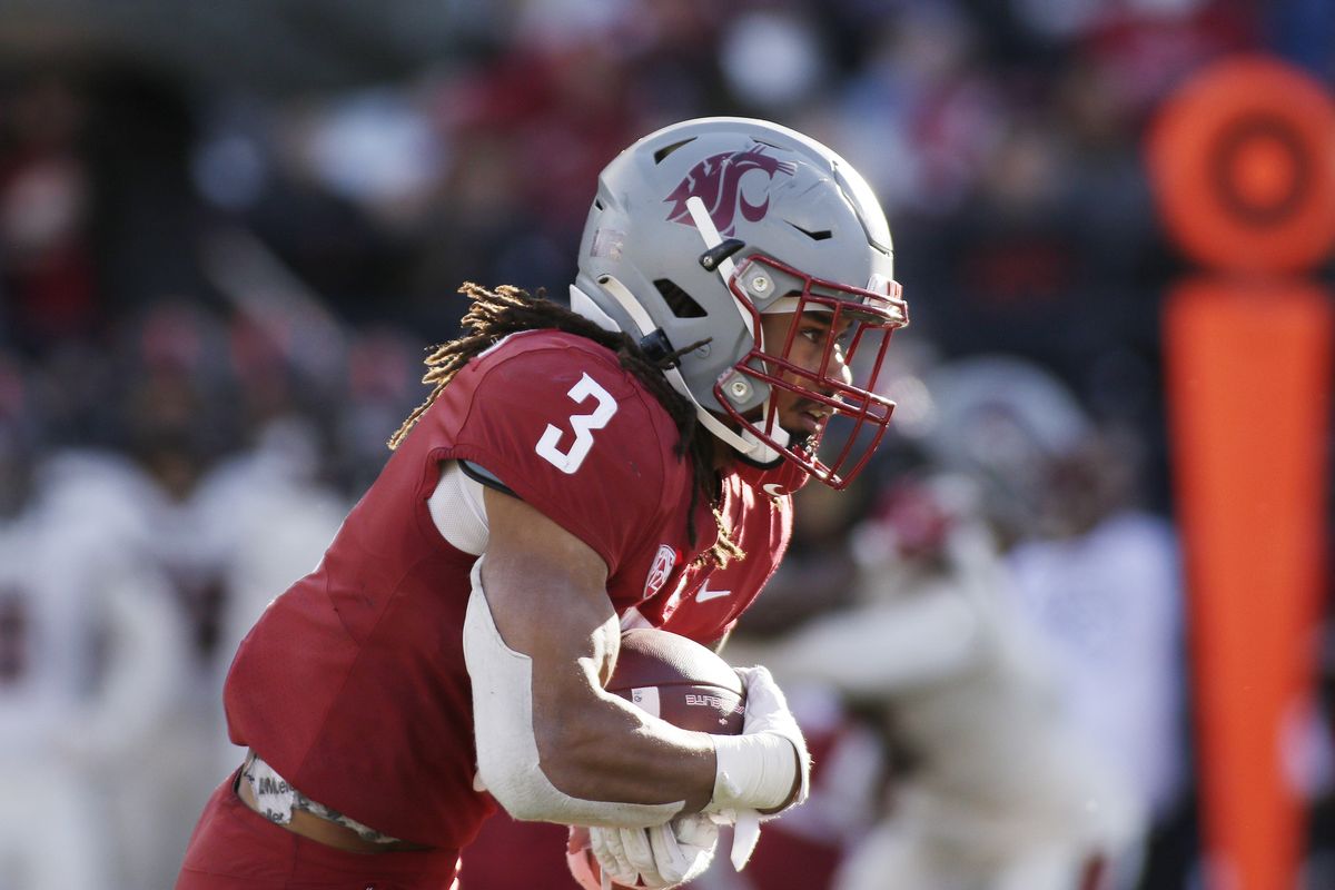 Cougars running back Deon McIntosh carries the ball during a Pac-12 Conference game against Oregon State last Saturday in Pullman.  (Associated Press)