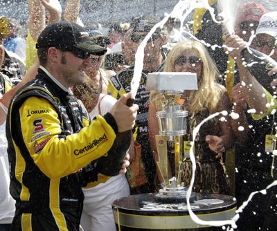 Paul Menard celebrates after winning the Brickyard 400 for his first career NASCAR Sprint Cup victory. (Associated Press)