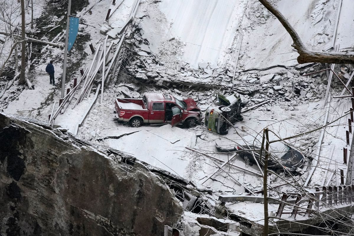 Vehicles that were on a bridge when it collapsed are visible, Friday Jan. 28, 2022, in Pittsburgh