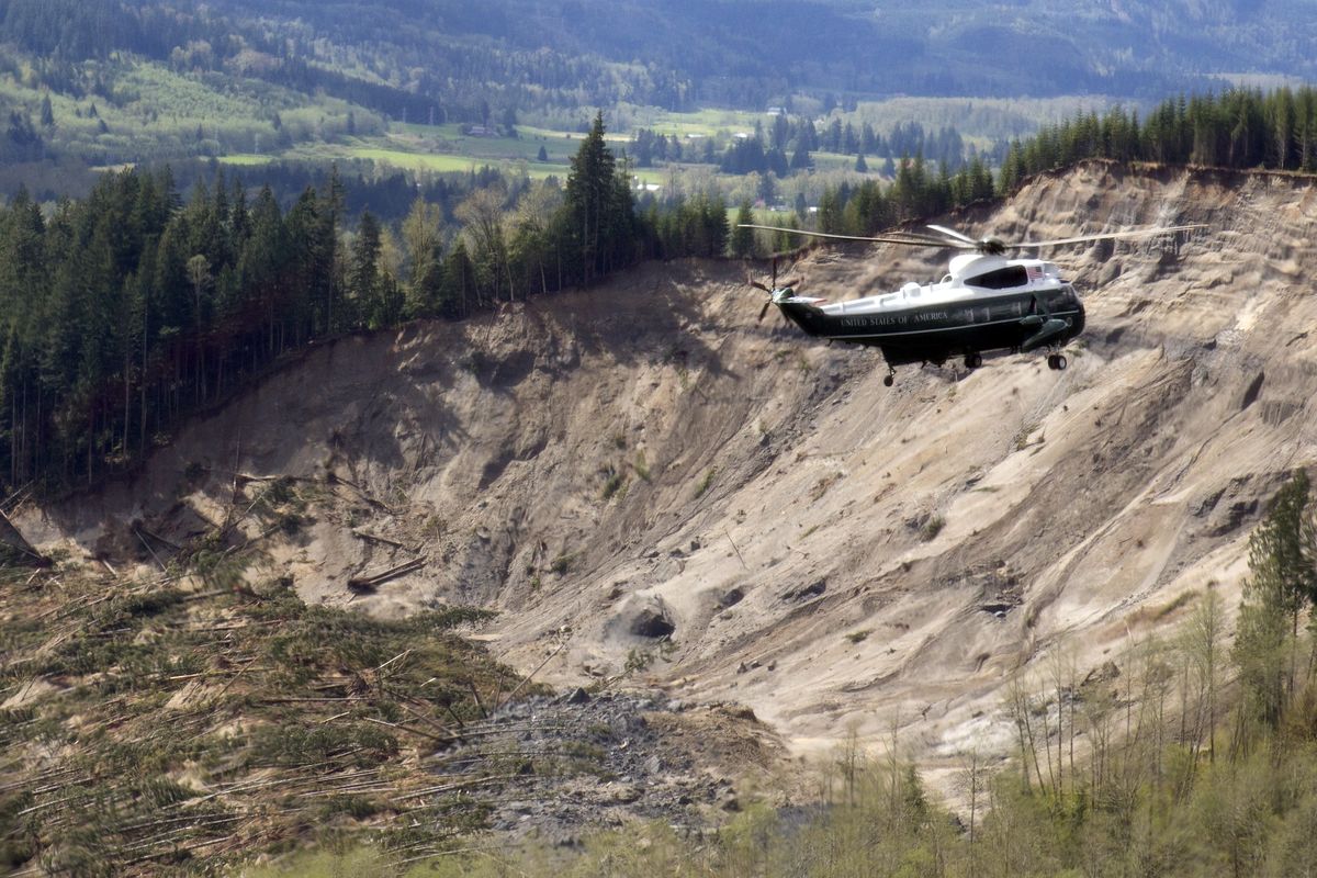 Helicopter Marine One, carrying President Barack Obama, takes an aerial tour on Tuesday above the mudslide site near Oso, Wash. (Associated Press)