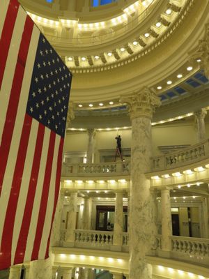 A maintenance worker works on a security camera high above the 4th floor rotunda in a quiet Idaho state Capitol on Friday morning, Jan. 19, 2018. (Betsy Z. Russell)