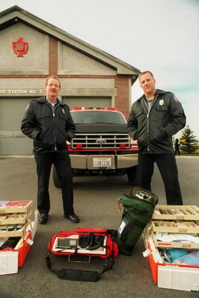 Valley fire fighters and paramedics Wayne McLaughlin and Steve Hatcher are ready for medical calls or ready to fight a fire in this Spokesman-Review file photo from 1995.  (File photo)