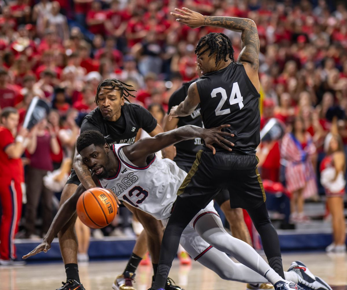 Gonzaga’s Graham Ike draws defensive attention from Long Beach State’s Ramel Lloyd (24) and Austin Johnson during the first half of GU’s 84-41 victory Wednesday at the McCarthey Athletic Center.  (COLIN MULVANY/THE SPOKESMAN-REVIEW)