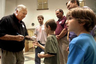 
Former New York Yankees second baseman Bobby Richardson autographs a baseball for Matthew Pleasant, 8, center, as Graham Stubbs, 9, right, looks on at Snyder Memorial Baptist Church in Fayetteville, N.C., last month.
 (Associated Press / The Spokesman-Review)