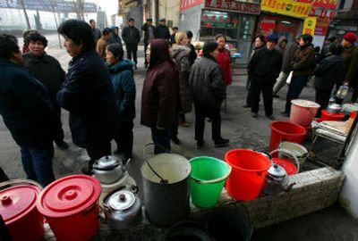 
Residents of Harbin, China, wait for a water delivery truck Sunday – the fifth day without running water after a toxic spill in the Songhua river caused authorities to shut off the city's water supply. 
 (Associated Press / The Spokesman-Review)