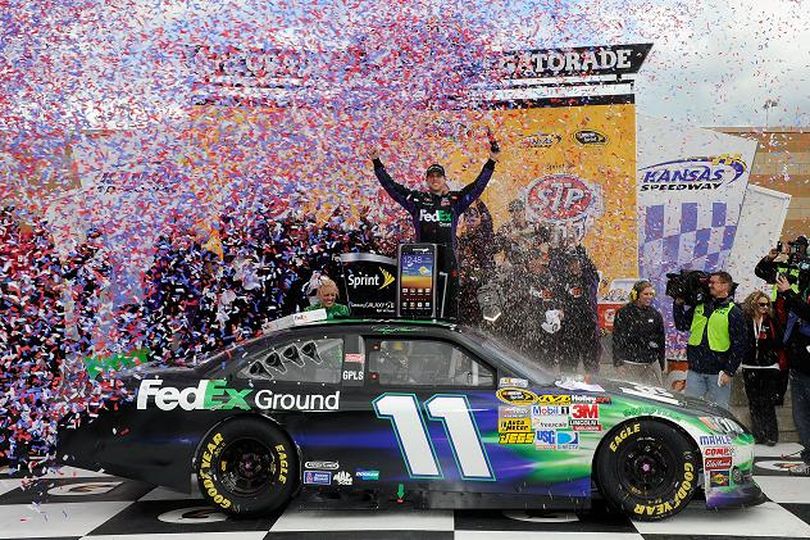 The No. 11 Joe Gibbs Racing team celebrates its second win of the 2012 season with Denny Hamlin after the NASCAR Sprint Cup Series STP 400 on Sunday at Kansas Speedway in Kansas City, Kan. (Photo Credit: Chris Graythen/Getty Images for NASCAR) (John Harrelson / Getty Images North America)