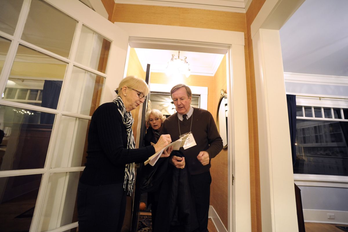 Volunteer Judy Stone, left, welcomes David Klempin and Linda Ratliff, of Grapevine, Texas, to a historic mansion on Sumner Avenue. The house is owned by Spokane Mayor David Condon, and he stood outside to welcome people to his home, one of 10 open for tours. (JESSE TINSLEY photos)