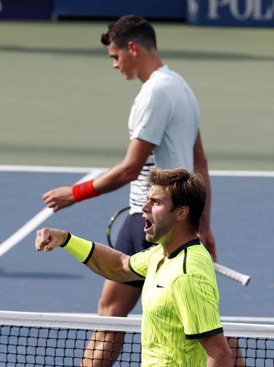 American Ryan Harrison, bottom, reacts after beating Milos Raonic. (Alex Brandon / Associated Press)