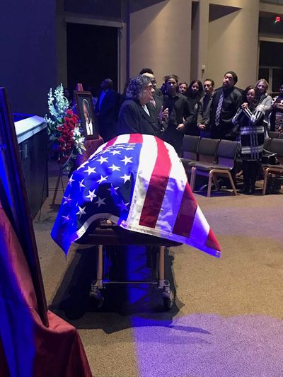 The widow of Happy Watkins sits near his casket during a Celebration of Life.  (Courtesy of Robert Robinson)