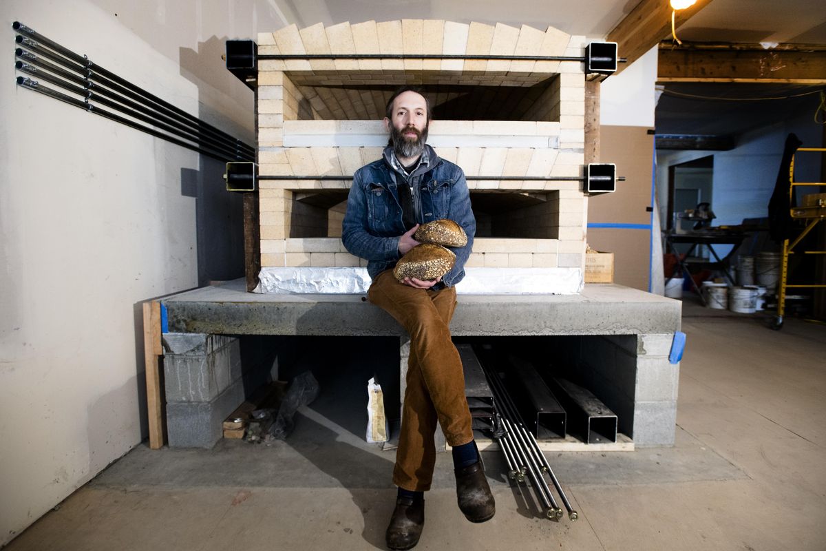 Shaun Thompson Duffy, owner of Culture Breads, poses for a photo with his new oven at the bread shop’s soon-to-open location at 1026 E. Newark Ave. (Tyler Tjomsland / The Spokesman-Review)