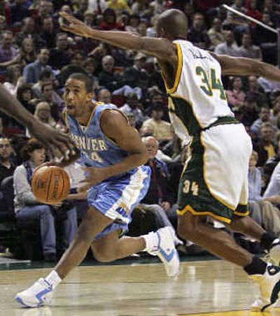 
Denver Nuggets' Andre Miller, left, drives to the basket as Seattle's Ray Allen defends. 
 (Associated Press / The Spokesman-Review)