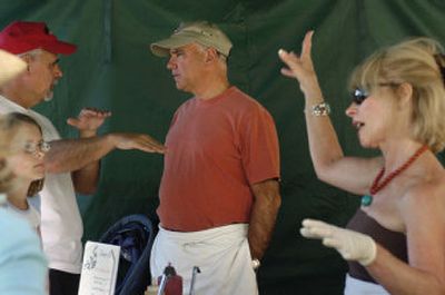 
Jim Frank talks to Mayor Steve Peterson, center, who visited the Liberty Lake Farmers' Market with his wife, Charmaine. 
 (Dan Pelle Spokesman-Review / The Spokesman-Review)