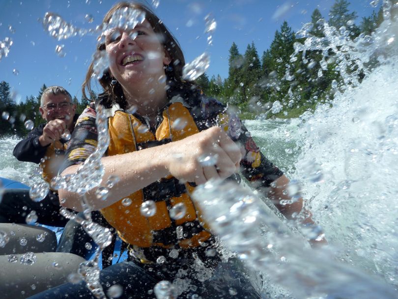 Whitewater washed: Michaela Williams takes a faceful of water in the Devil’s Toenail rapids while rafting the Spokane River on Saturday with Wiley E. Waters rafting company during the Washington State Parks Centennial Celebration. Chris Guidotti, Riverside State Park manager, wisely took a position behind Williams and stayed much drier. (Rich Landers)