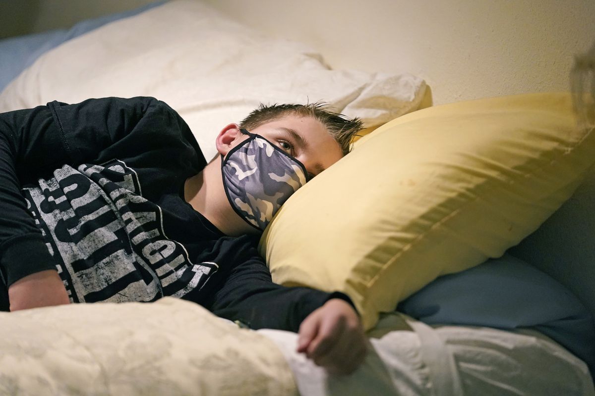 Cooper Wuthrich rests as he lays on a bed at the truck stop his family partly owns Tuesday, Dec. 15, 2020, in Montpelier, Idaho. Shortly after Thanksgiving, Wuthrich, 12, became one of hundreds of children in the U.S. diagnosed with a rare COVID-19 complication that landed him in an emergency room three hours away from his tiny hometown in a secluded Idaho valley. The boy