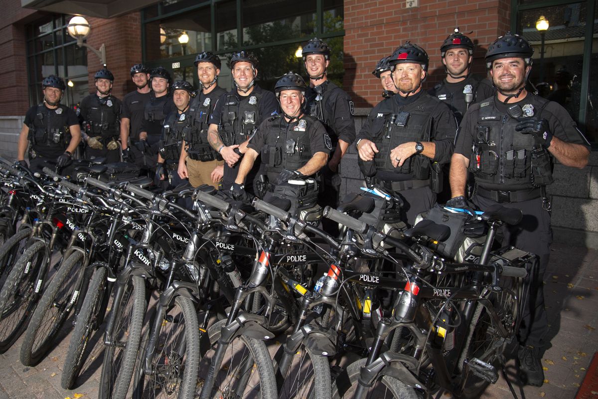 Spokane Police officers, who have been training for the department’s Bike Patrol Team, part of which will work out of the new downtown precinct at Wall and Riverside, pose for a photo before their inaugural ride Wednesday, October 7, 2020. The training materials come through the International Police Mountain Bike Association.  (Jesse Tinsley/The Spokesman-Review)