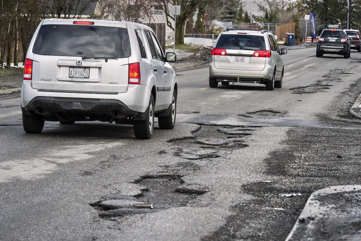 Vehicles headed north on Freya at Hartson avoid a stretch of potholes on the east side of the street, Feb. 17, 2017, in Spokane, Wash. Dan Pelle/THE SPOKESMAN-REVIEW (Dan Pelle / The Spokesman-Review)