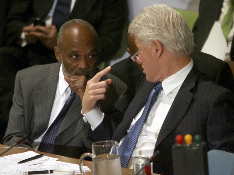 Haitian President Rene Garcia Preval, left, speaks to former U.S. President Bill Clinton during the opening session of the International Donors' Conference towards a 
