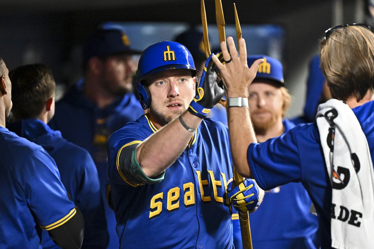 Seattle’s Luke Raley celebrates with teammates in the dugout Friday after hitting a solo home run during the fifth inning against the San Francisco Giants in Seattle.  (Alika Jenner)