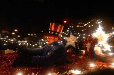 
Jim Durham drives a float down Sherman Avenue on Friday during Coeur d'Alene's holiday parade. Dozens of floats and two high school marching bands took part. 
 (Jesse Tinsley / The Spokesman-Review)