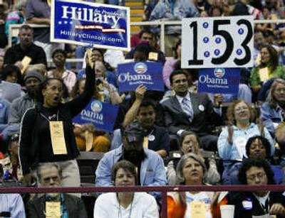 
Delegate Helda Martins, left, holds her sign in support of Hillary Clinton as others hold signs for Barack Obama during the Travis County Democratic convention Saturday, in Austin, Texas. Associated Press
 (Associated Press / The Spokesman-Review)