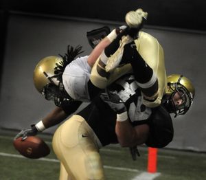 As Idaho running back Corey White dives for the end zone, he is denied six points by linebacker John McKinley who tackled White out-of-bounds during the  Silver and Gold game in the Kibbie Dome in Moscow Friday April 23, 2010 COLIN MULVANY (Colin Mulvany / The Spokesman-Review)