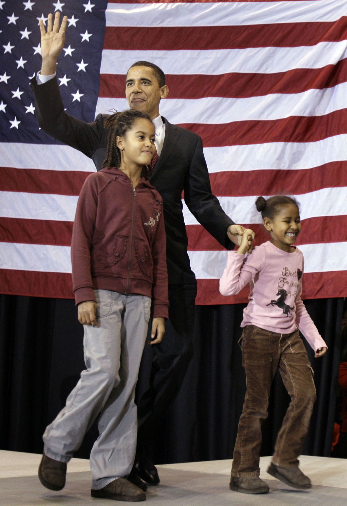 President-elect Barack Obama and his daughters Malia, left, and Sasha, leave the stage after a campaign event in Des Moines, Iowa, earlier this year. Caring for the children and the country will be a major challenge for the Obamas, but they may get some help from Michelle Obama’s mother, who could move into the White House and be with the kids while the parents are attending events on the road. (M. Green / The Spokesman-Review)